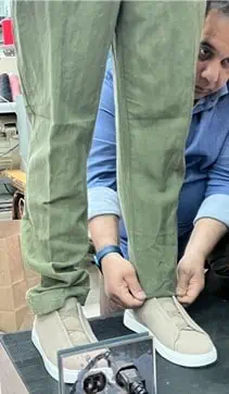 a person getting their pants tailored