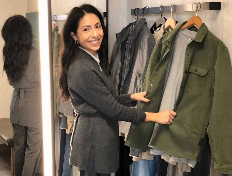 Cassandra Sethi with a rack of clothes