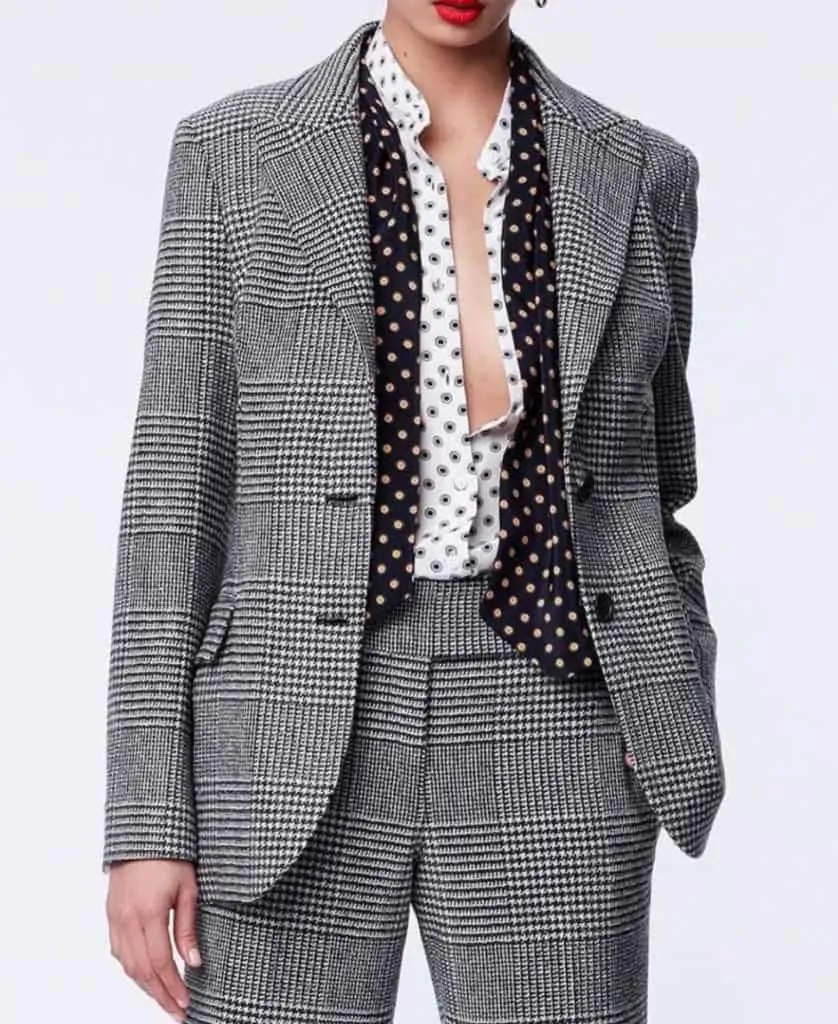 women's torso wearing black and white printed suit and blouse