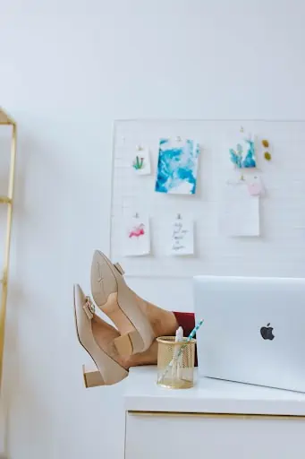 Woman With Feet Up On Desk Showing Off Her Office Shoes For Women