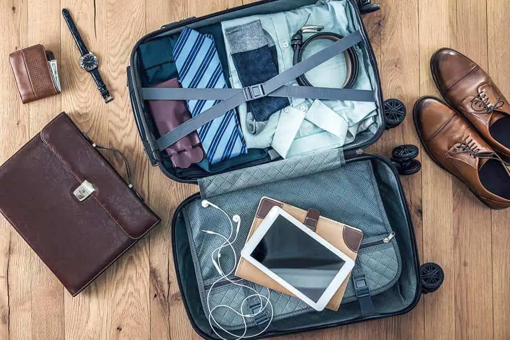 men's suitcase being packed for a business trip