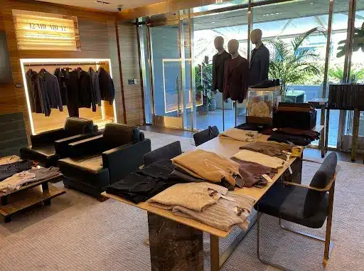 A Private Waiting Room Layed Out With Clothes For Ramit Sethi's How to Get Rich Wardrobe