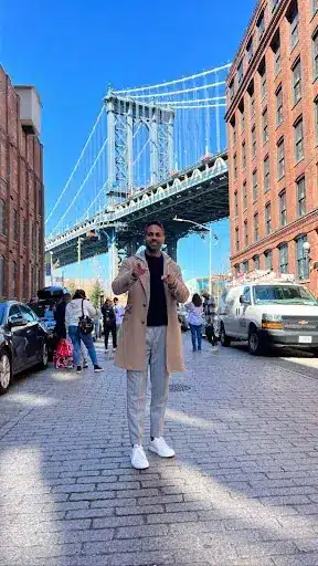 Finance Expert Ramit Sethi Wearing A Sweater On The Set Of Netflix's How To Get Rich