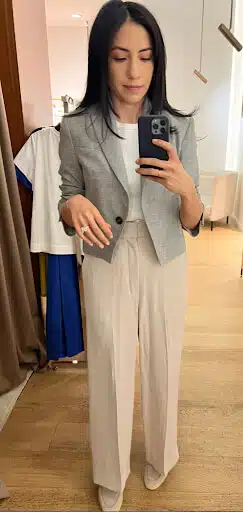 Cassandra Sethi taking a mirror selfie in a plain white t-shirt