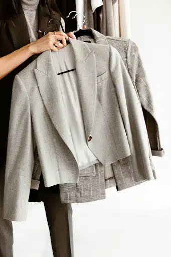 Stylist holding blazers