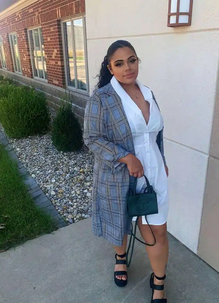 Image depicting a mid-size woman wearing a layered executive style outfit.