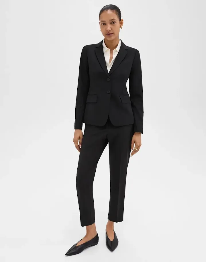 Image of an executive lawyer in a black pantsuit and crisp white blouse