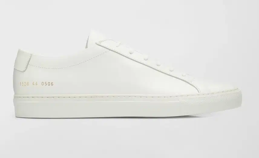 White leather tech bro shoes by common projects.