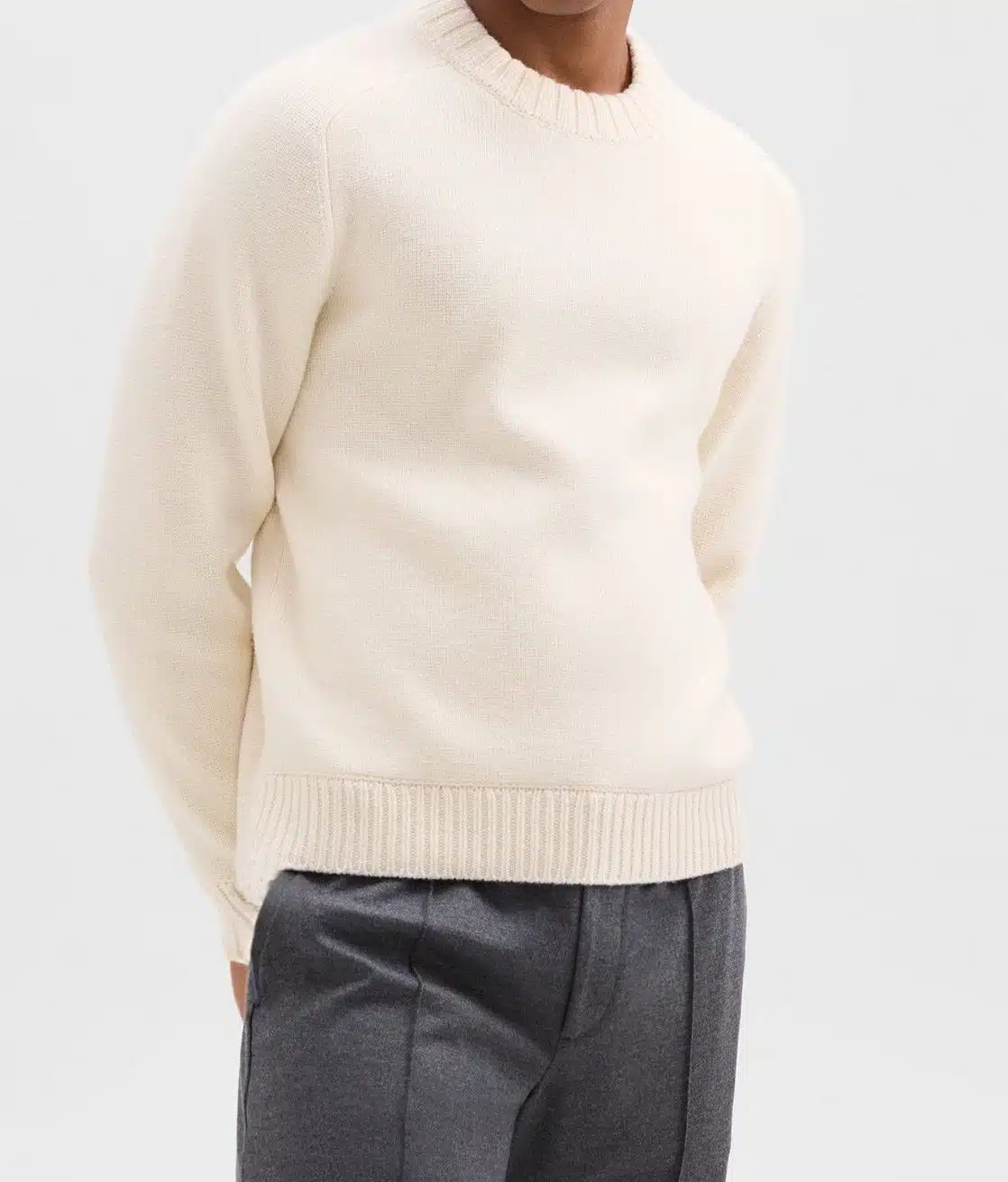 Image of an attorney wearing an off-white wool crewneck sweater for a put-together executive look.